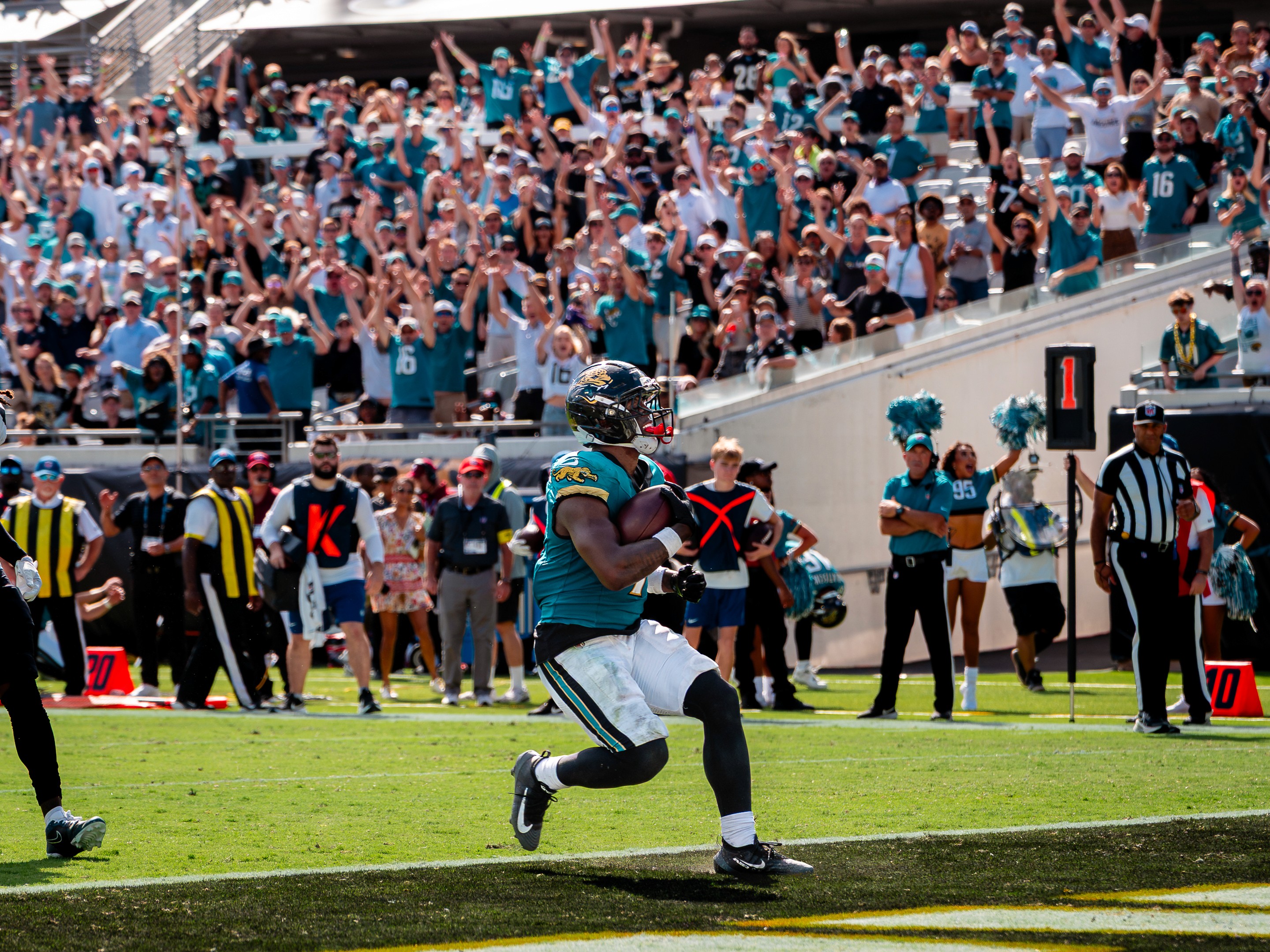 TOUCHDOWN across the EverBank Stadium board as the offense walks back — Lawrence (16), Tuten (33), Strange (85) and the line.
