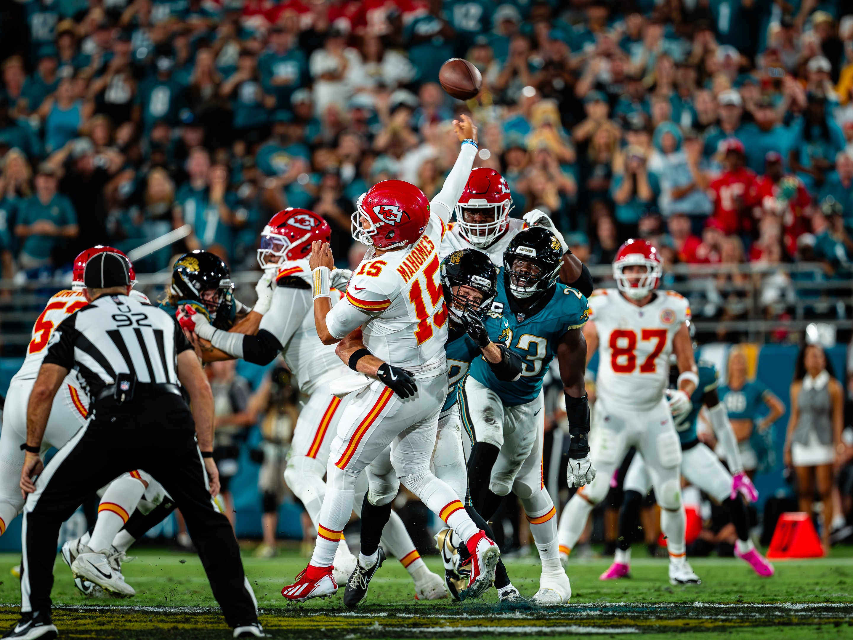 Patrick Mahomes (15) gets the ball out as the Jaguars pass rush arrives.