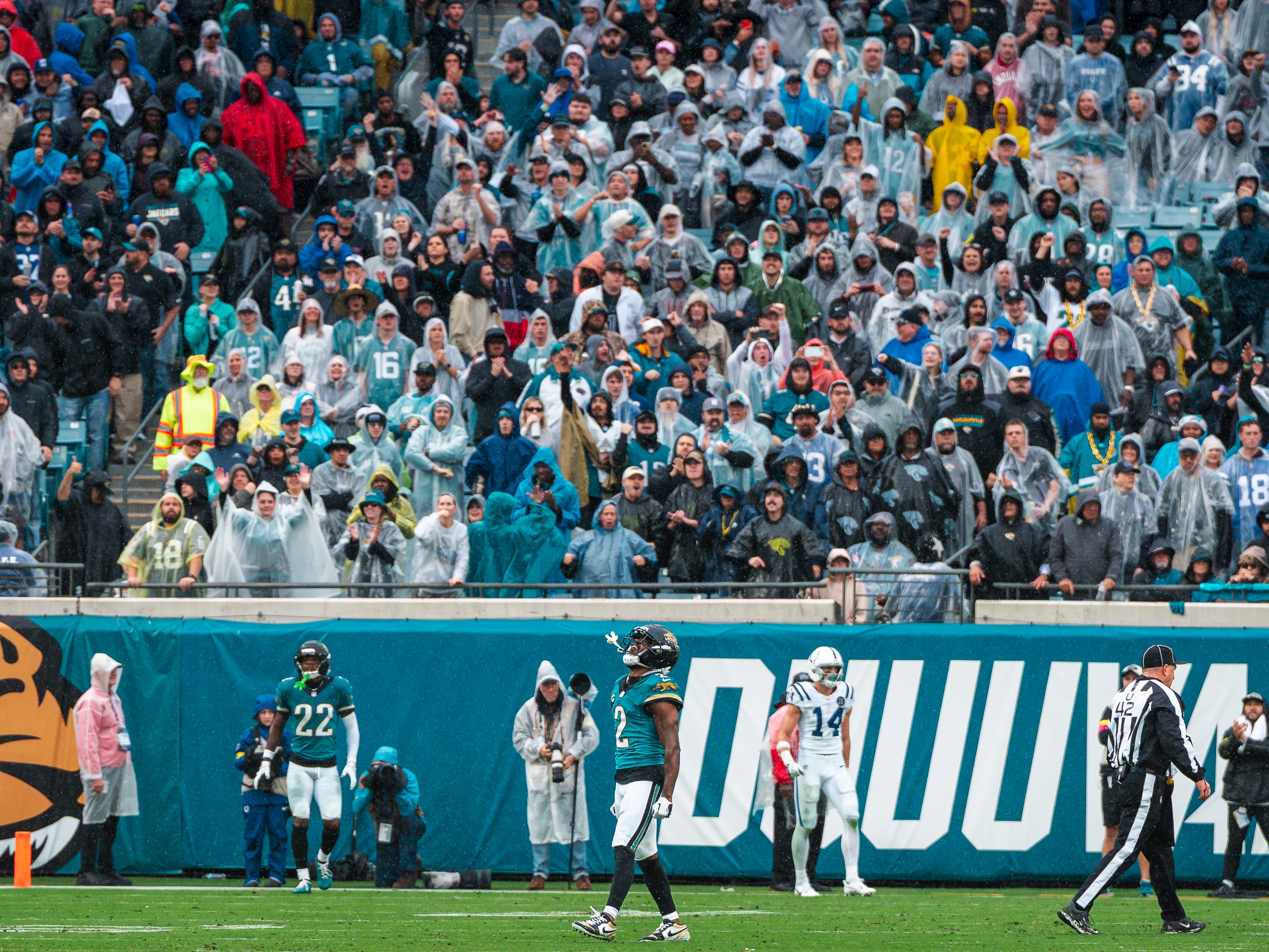 A rain-soaked crowd in ponchos behind the Jaguars sideline during the Colts game at EverBank Stadium.