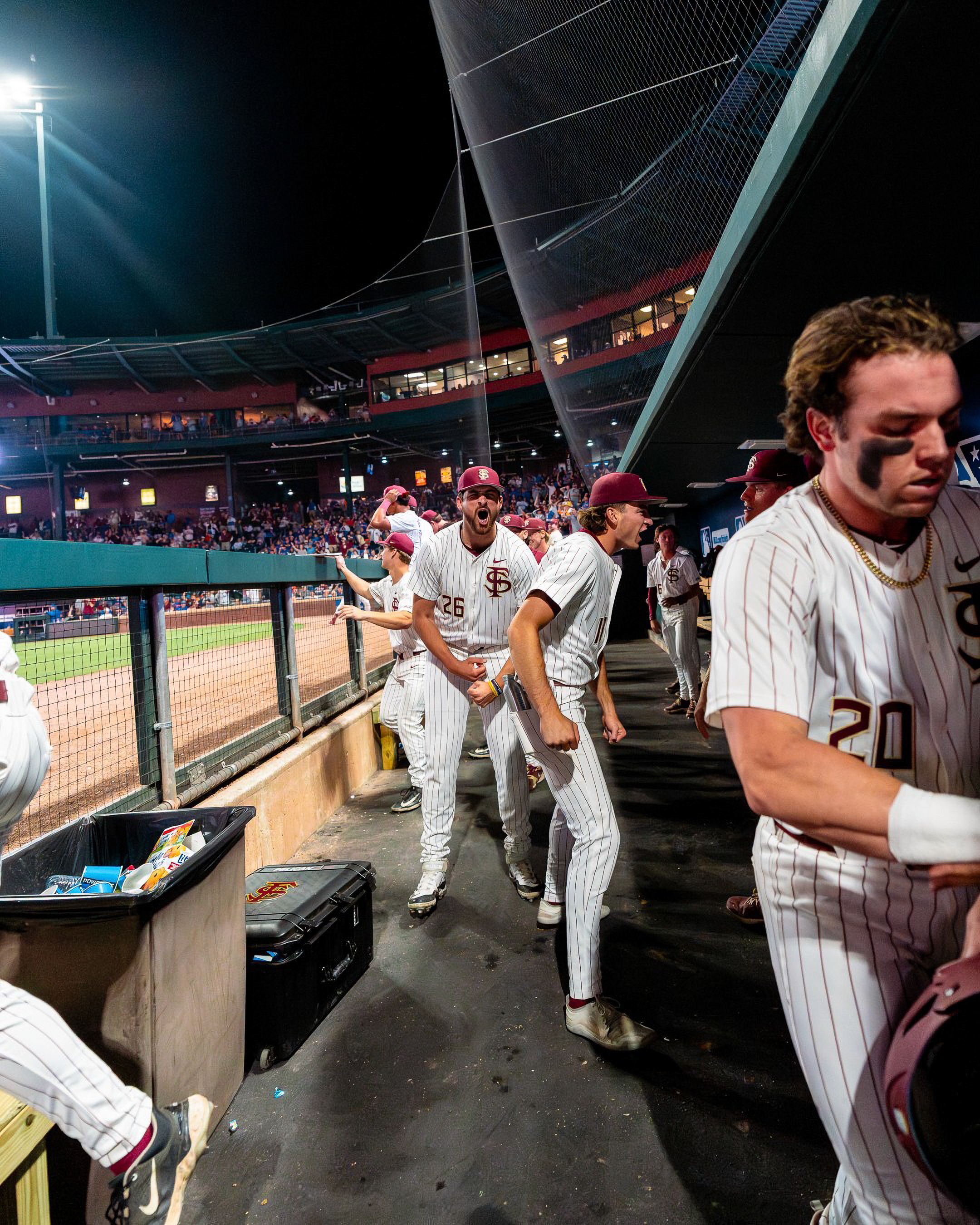 The Florida State dugout comes unglued under the lights at 121 Financial Ballpark in Jacksonville.