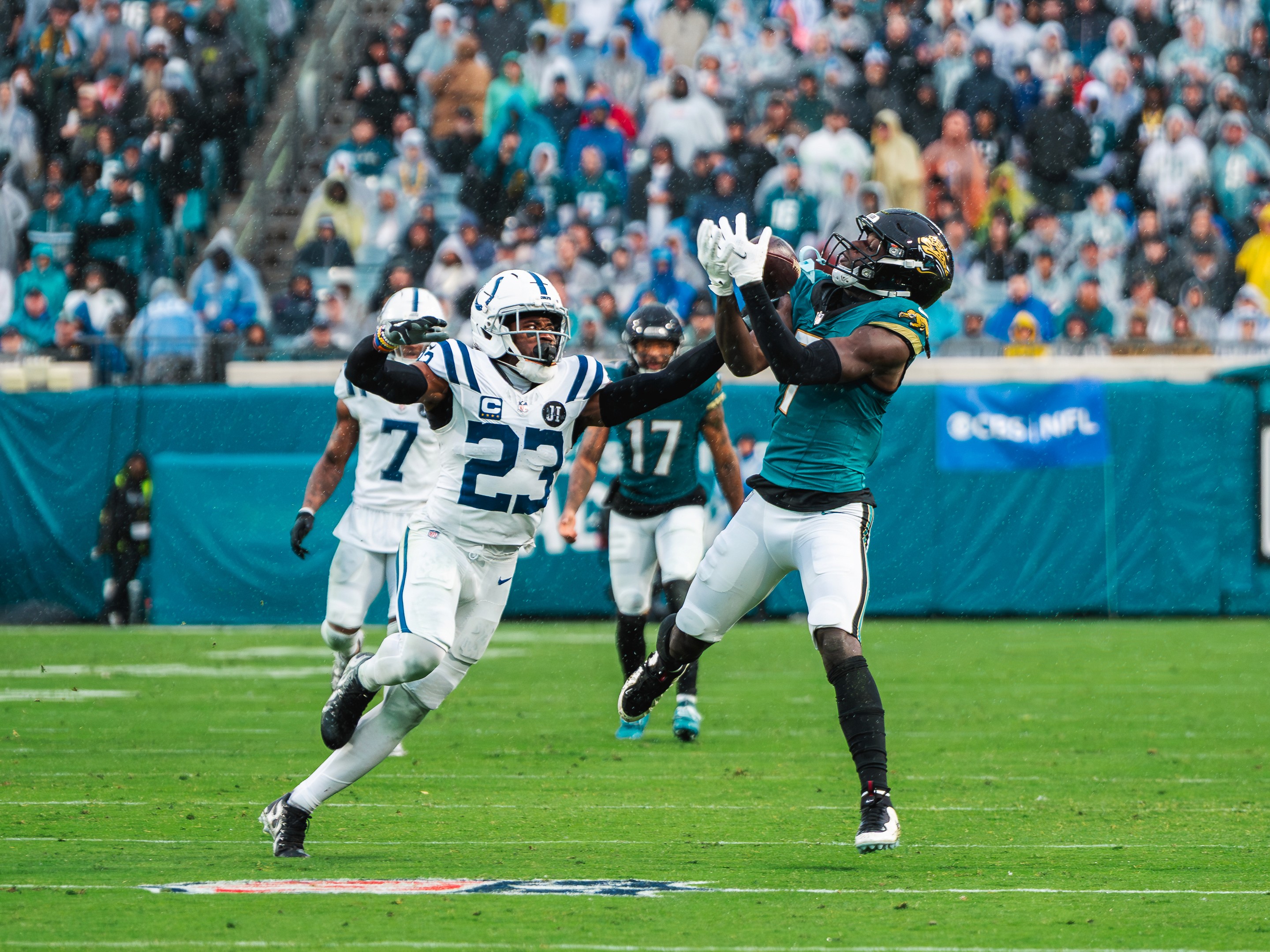 A Jaguars receiver pulls in a pass in front of Colts cornerback Kenny Moore II (23).