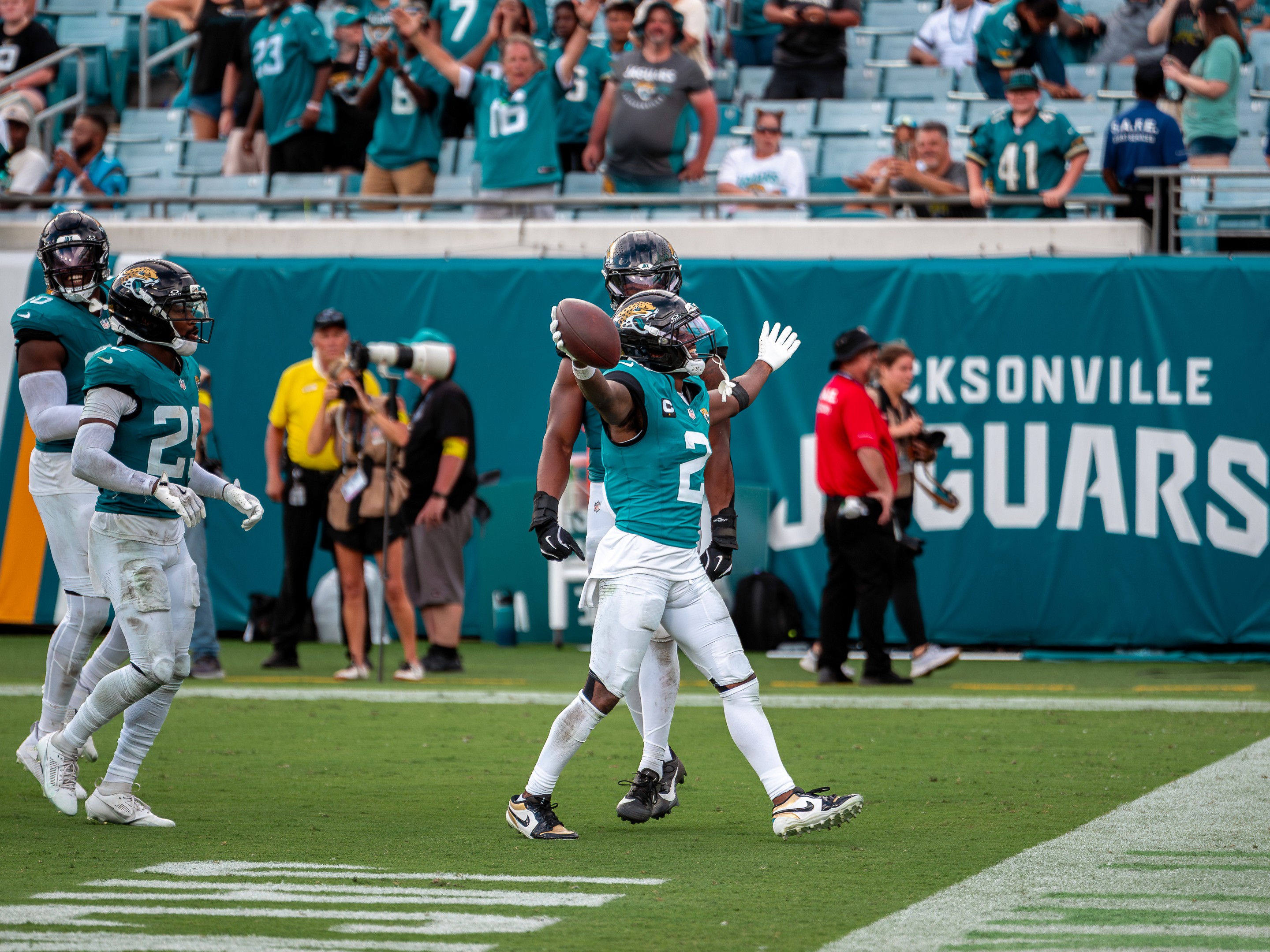 A Jaguars defensive back shows the ball to the stands after a takeaway.