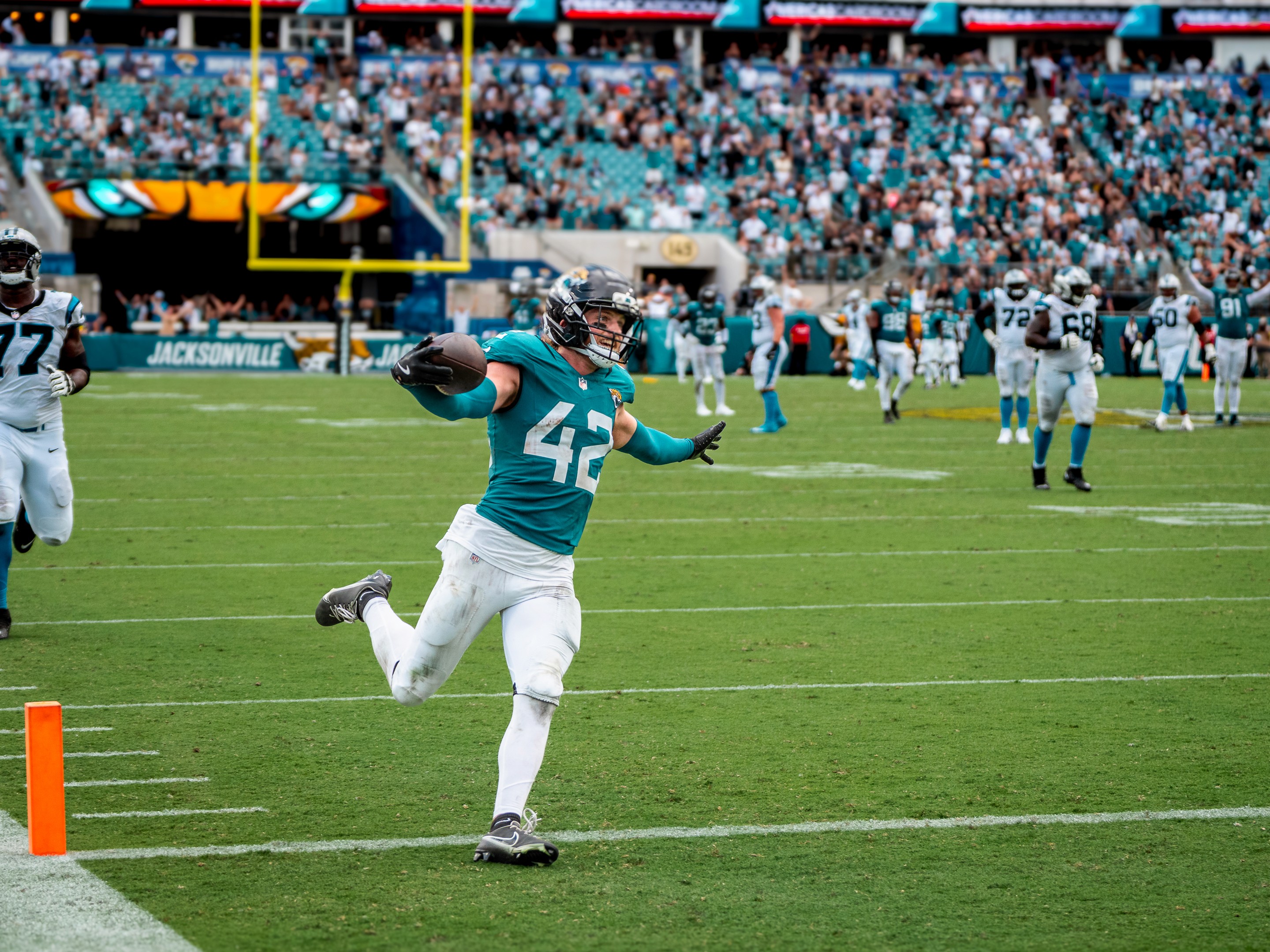 Safety Andrew Wingard (42) with the ball after his interception, heading for the pylon.